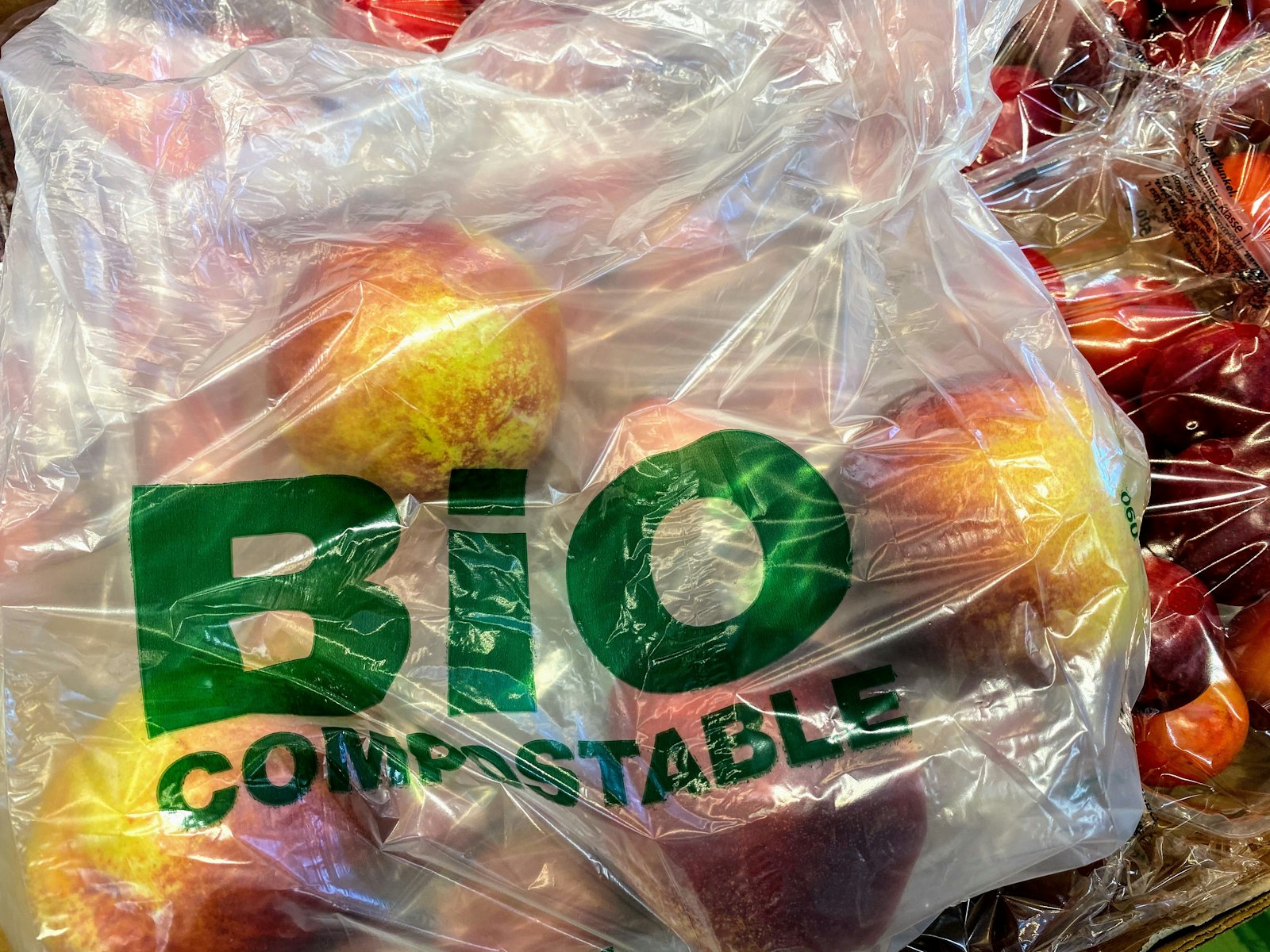 A clear compostable produce bag holding fresh fruit