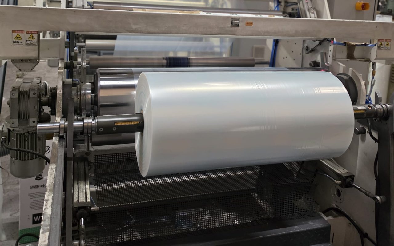 A roll of clear layflat polythene tubing winding off the extrusion line