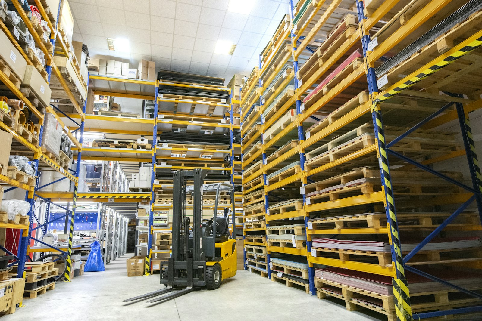 Palletised loads in a warehouse protected with polythene covers
