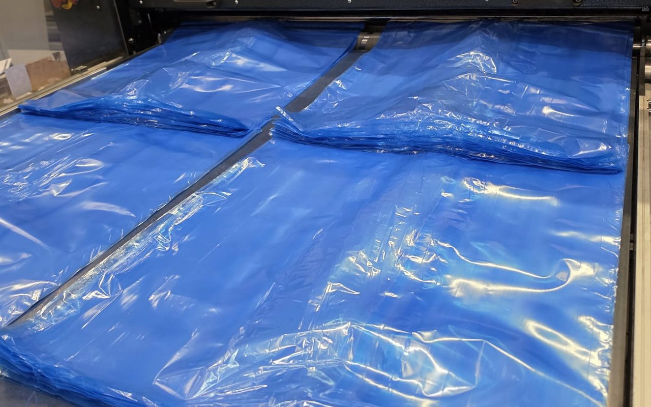 Blue bottom-sealed polythene bags coming off the sealing line at our Blackburn factory